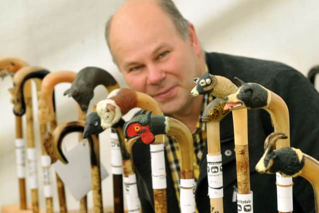 William Lambert, the walking stick steward, looks at the Ornamental Horn walking stick section.