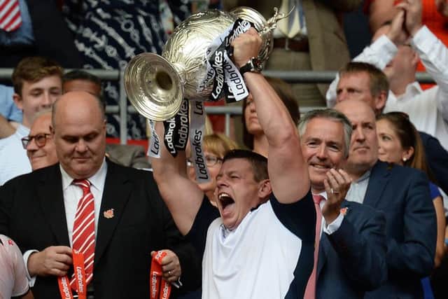 Hull FC coach Lee Radford lifts the trophy as they celebrate winning the Challenge Cup Final match at Wembley Stadium, London. (Picture: PA)