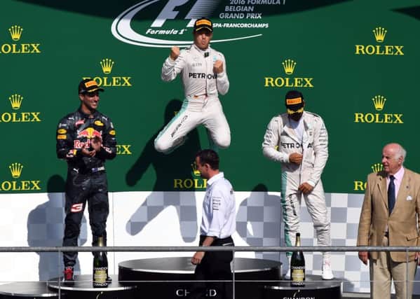 Mercedes driver Nico Rosberg, centre, celebrates, with Red Bull driver Daniel Ricciardo, left, in second place and team-mate Lewis Hamilton in third. Picture: AP/Geert Vanden Wijngaert