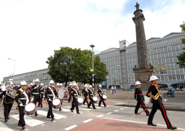 The Band of Her Majesty's Royal Marines pass the William Wilberforce Monument in Hull on Yorkshire Day