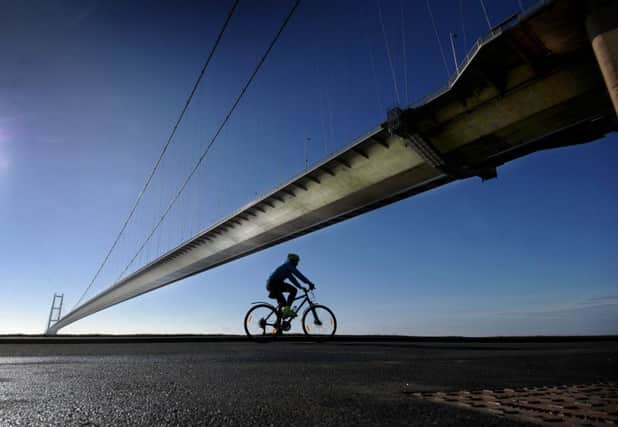 A cyclist rides under the Humber Bridge. Picture by Simon Hulme