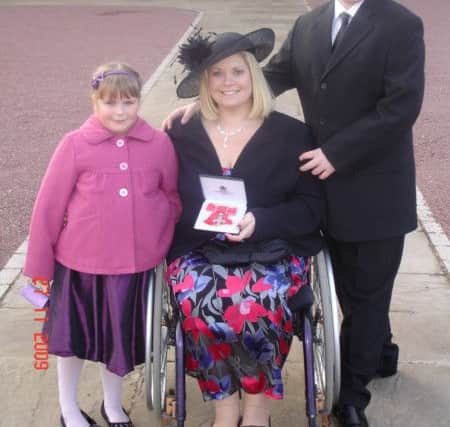 Sue Gilroy table tennis champion from Dodworth,  at Buckingham Palace with her children Ryan and Lauren, after receiving her MBE for services to sport and young people  in 2009