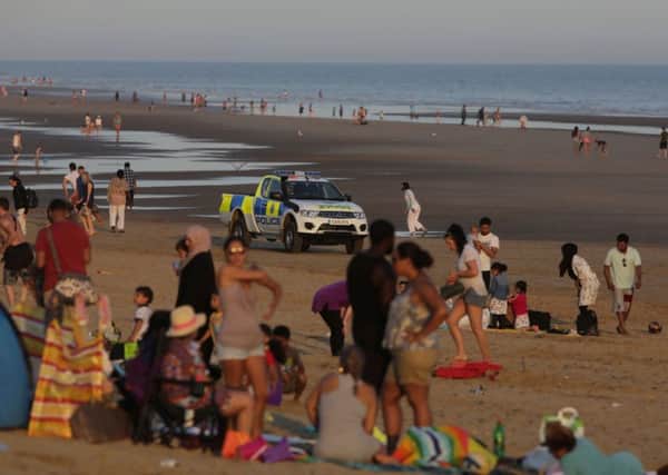 Police officers on Camber Sands, East Sussex where five young men died on the hottest day of the year. Photo: Gareth Fuller/PA Wire.