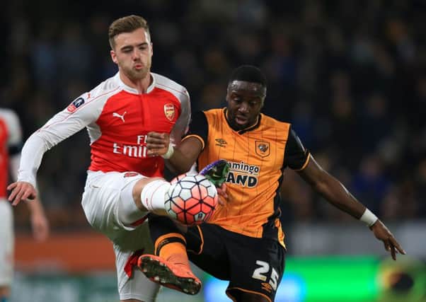 Arsenal's Calum Chambers (left) and Hull City's Adama Diomande battle for the ball.