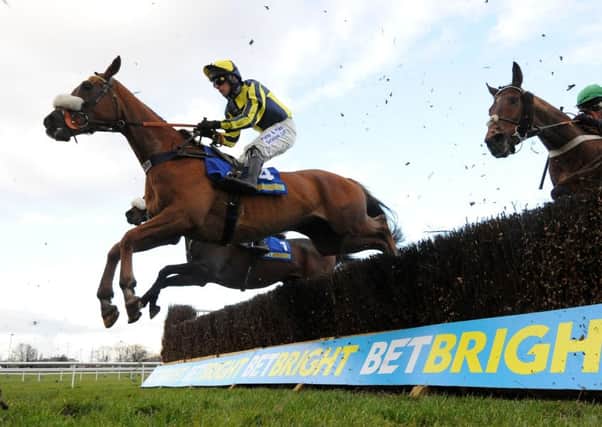 The Last Samuri, ridden by David Bass, clears a fence on its way to winning the BetBright Grimthorpe Chase at Doncaster (Picture: Anna Gowthorpe/PA Wire).