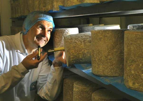 Wensleydale Creamery managing director David Hartley sampling a cheese iron of Yorkshire Wensleydale cheese.