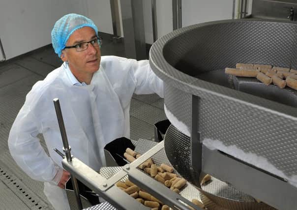 Kevin Brennan watching Quorn cocktail sausages being manufactured