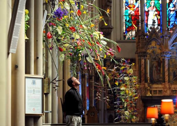 Leeds Minster celebrates 175 years with contemporary Floral designs.. Rev Canon Simon Corley pictured with one of the Floral Design in the Minster...1st September 2016 ..Picture by Simon Hulme