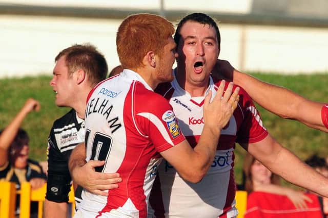Hull KR's Paul Cooke celebrates his second try with Kris Welham (left)