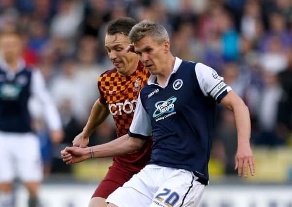 Bradford City's Tony McMahon, left, battles for the ball with Millwall's Steve Morison during the League One play-off semi-final at The Den (Picture: Steven Paston/PA Wire).