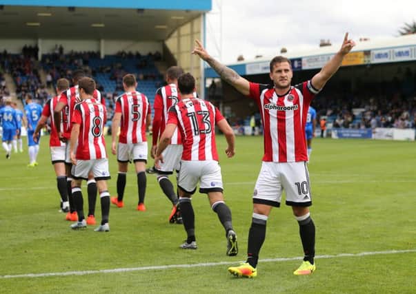 HOW'S THAT? Sheffield United's Billy Sharp celebrates scoring his side's winning goal at Gillingham. Picture: David Klein/Sportimage
