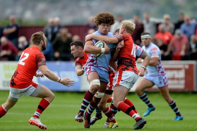 BLOCKED: Rotherham Titans' Buster Lawrence, is tackled by London Welsh's Joe Carlisle. Picture: James Hardisty