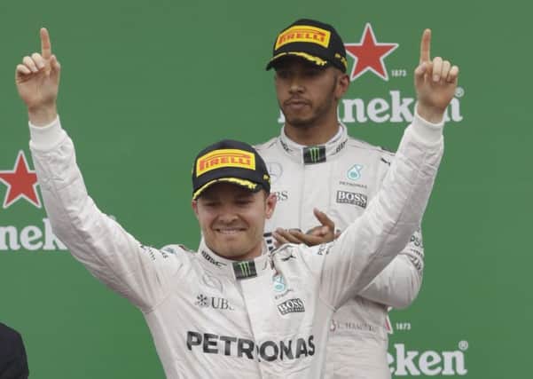 WELL DONE: Nico Rosberg of Germany, left, celebrates as secondplaced Mercedes teaam-mate Lewis Hamilton of Britain applauds Picture: AP Photo/Luca Bruno.