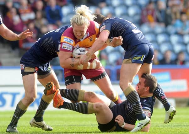 Huddersfield's Eorl Crabtree breaks through the Hull KR defence (Picture: Simon Hulme).