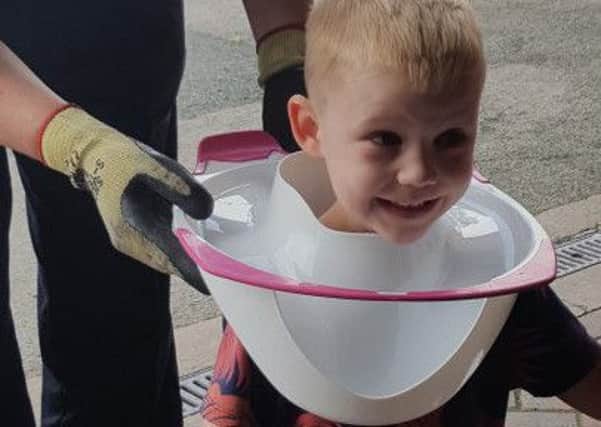 Luca, aged four, had to be helped by firefighters after getting his head trapped in a toilet seat. Picture: South Yorkshire Fire Service.