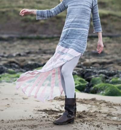 Patricia Stienstra modelling a fine grey and pink jumper with sea shell drape taken at a beach north of Scarborough - by Jo Dennison.
