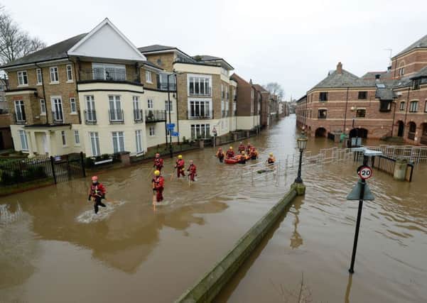 Rescuers wade through York during the floods.