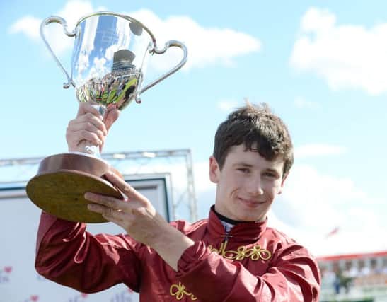 Oisin Murphy with the trophy after riding Simple Verse to victory in the DFS Park Hill Stakes at Doncaster (Picture: Anna Gowthorpe/PA Wire).