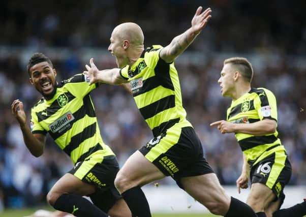 Huddersfield Town's Aaron Mooy (centre) celebrates scoring.
