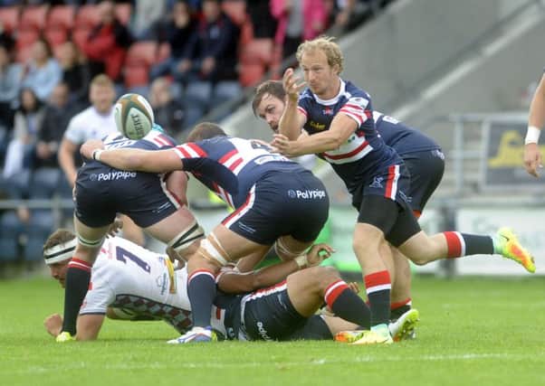 Doncaster player Michael Heaney passes out of the scrum.