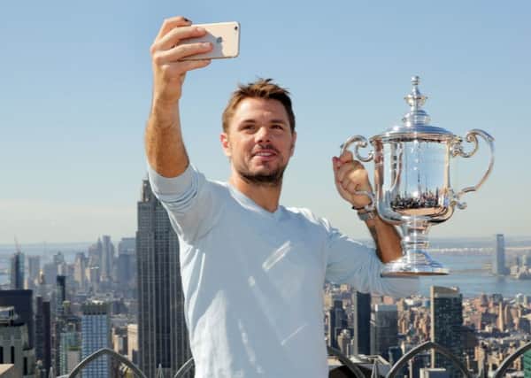 US Open men's singles tennis champion Stan Wawrinka takes a selfie picture as he poses for photos at the "Top of the Rock," in New York's Rockefeller Center. Picture: AP/Richard Drew.
