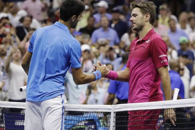 Stan Wawrinka greets Novak Djokovic at the net after winning the men's singles final of the US Open. Picture: AP/Darron Cummings.