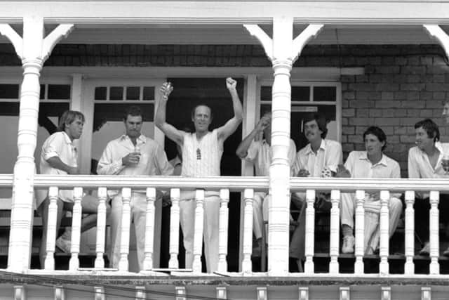 Geoffrey Boycott celebrates victory on the balcony at Trent Bridge against Australia with a glass of champagne and members of both sides.