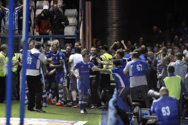 Chaos in the stands after Kieran Lee's late winning goal. Picture: Steve Ellis