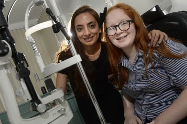 13 year old Becky Crossthwaite at Hunslet Carr Vision Centre where she was diagnosed with a brain tumour.  Pictured with optomotrist Kiran Lally