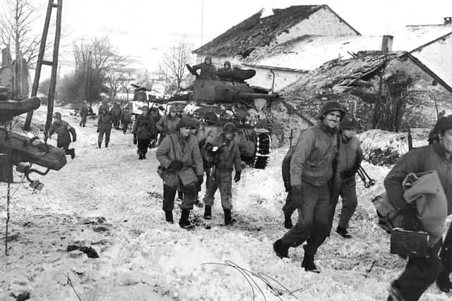 Allied soldiers pictured near Butgenbach in the Ardennes in 1944.