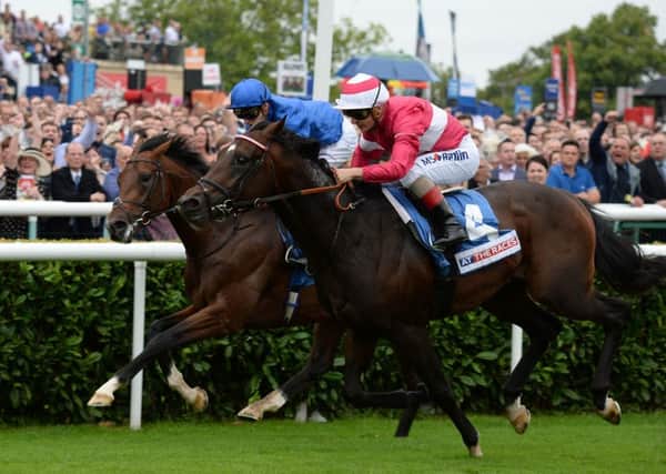 Rivet ridden by Andrea Atzeni (right) beats Thunder Snow ridden by James Doyle to win the At The Races Champagne Stakes during day four of the 2016 Ladbrokes St Leger Festival.