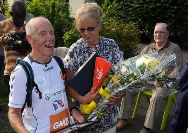 Ray Matthews with his wife Maureen after he has finished his 75th marathon at Newman School. Picture: Andrew Roe
