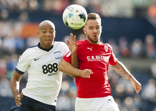 Barnsley's Adam Armstrong tangles with Preston North End defender Alex Baptiste