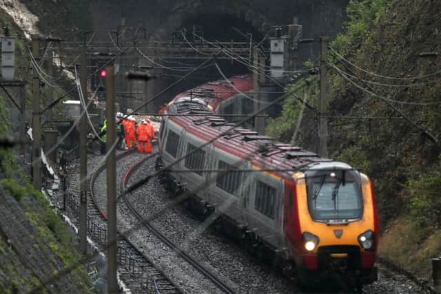Flash flooding hit parts of the South East with thunderstorms dumping almost half a month's rain in a few hours and derailing a train at Watford.