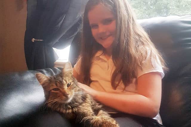 Ellie Murchison, 9, with her cat Max, who was shot up the nose with an air rifle