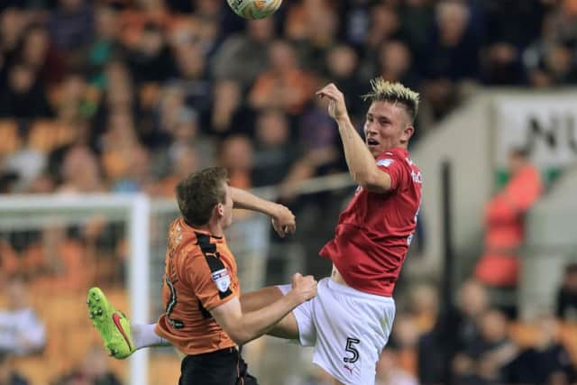 Angus MacDonald, seen playing against Wolves, has won all three games he has played in a Barnsley shirt (Picture: PA).