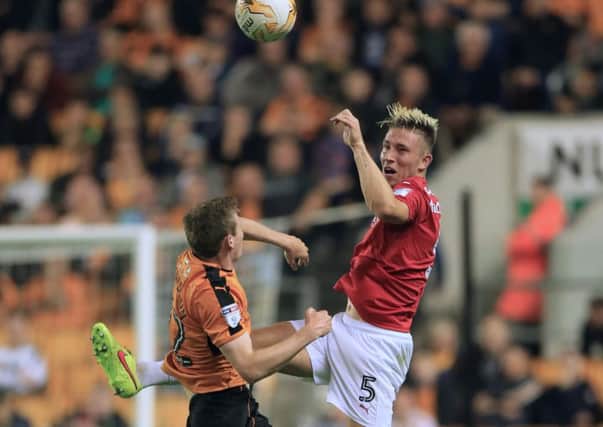 Angus MacDonald, seen playing against Wolves, has won all three games he has played in a Barnsley shirt (Picture: PA).