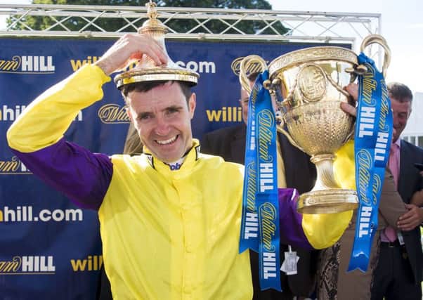 Jockey Tom Eaves celebrates winning The William Hill Ayr Gold Cup on Brando. Picture: Craig Watson/PA