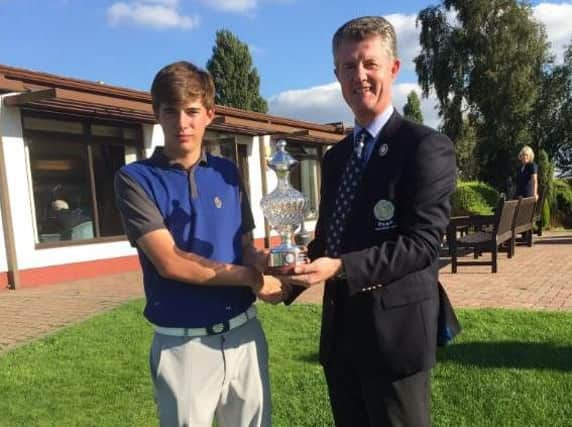 Yorkshire match play champion Bailey Gill receives the trophy from Yorkshire Union of Golf Clubs' president Jonathan Plaxton.