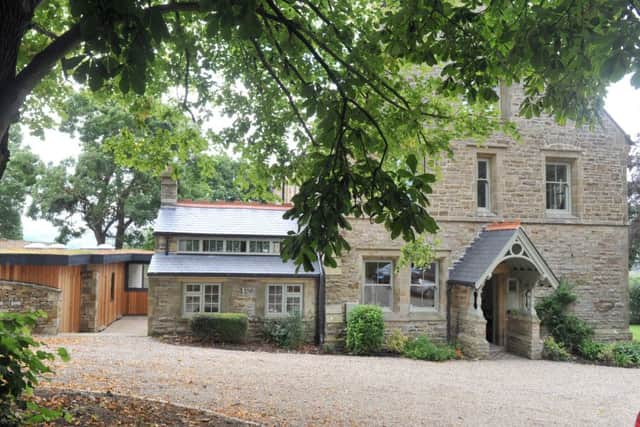 The rear of the new stone and cedar clad annexe next to the Victorian vicarage, now a contemporary B&B