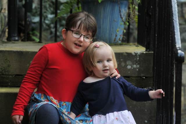 Evie Swales, 6, with her young sister Libby, 18 month