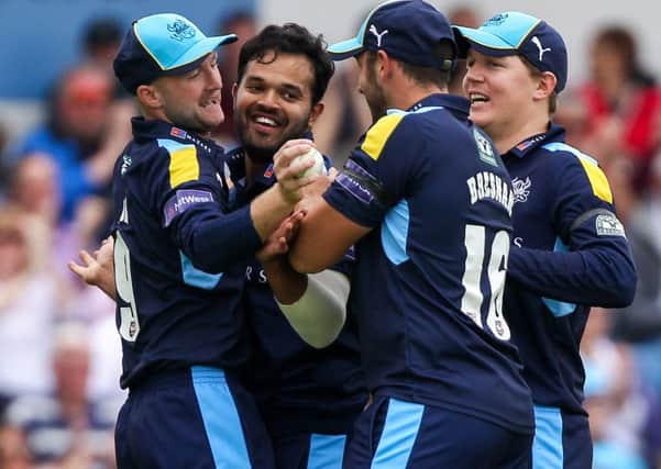 Azeem Rafiq, second left, shows his delight at agreeing a new deal with Yorkshire. Picture: Alex Whitehead/SWpix.com
