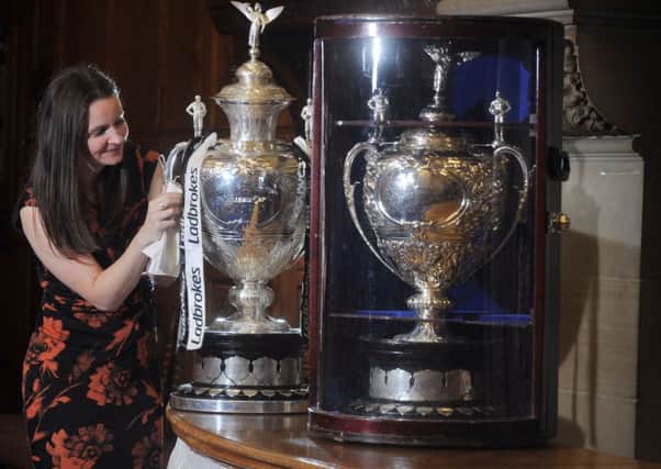 Brigid Power Heritage Manager for Rugby League Cares with the original and present Challenge Cups at a launch event to announce that Bradford is to be the home of National Rugby League Museum.  Picture Tony Johnson.