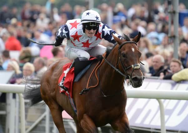 HEADING FOR THE LINE: Heartbreak City, ridden by Adam McNamara, pictured winning the Betfred Ebor during day four of the 2016 Yorkshire Ebor Festival at York last month. Picture: Anna Gowthorpe/PA Wire