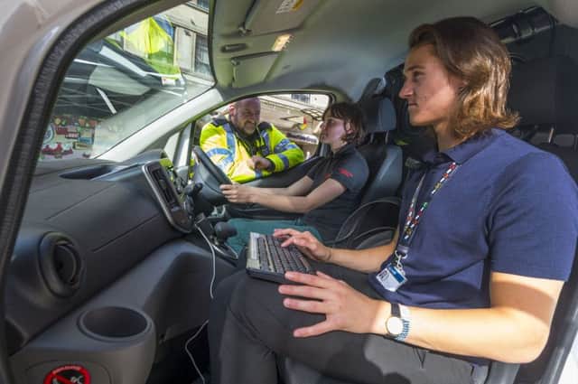 Date: 21st September 2016. Picture James Hardisty. Members of the public walking through Dortmund Square, Leeds, are been invited to test how good they are at understanding braking distances by the help of a special simulator. Pictured West Yorkshire Police Safety Roads and Neighbourhood Support Offficer PC Andy Chadwick, watching the reaction of Beth Booton, whilst Luke Morris operates the vehicle.