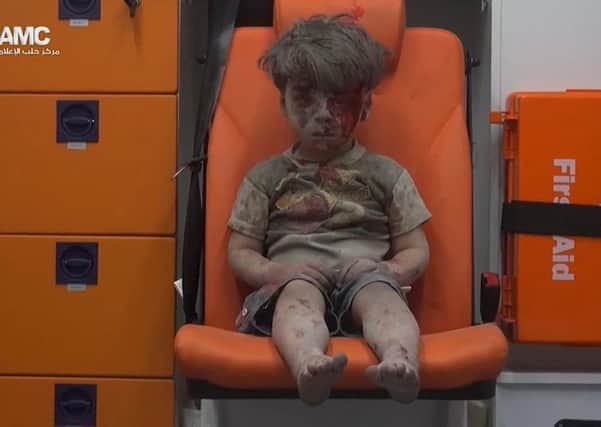 Alone in the world, this little boy sits in the back of an ambulance in Aleppo after being rescued from the rubble of a bombed building as the campaign grows for the White Helmet aid workers to be given the Nobel Peace Prize.