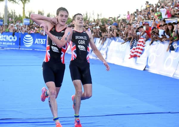 Britain's Alistair Brownlee, left, helps his brother Jonny to get to the finish line during the Triathlon World Series event in Cozumel, Mexico, a feat which has taken sportsmanship to new levels.