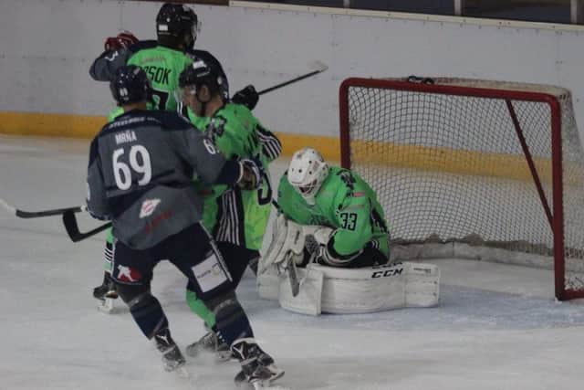 NO WAY THROUGH: Hull goaltender Jordan Marr smothers a shot as Sheffield Steeldogs' Pavel Mrna looks for the rebound. Picture: Lois Tomlinson.