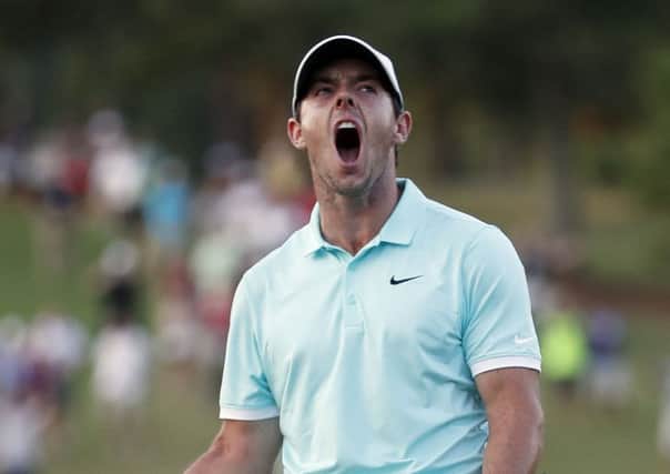 Rory McIlroy reacts after sinking a putt on the fourth hole to win the Tour Championship golf tournament and the FedEx Cup at East Lake Golf Club in Atlanta. (AP Photo/John Bazemore)