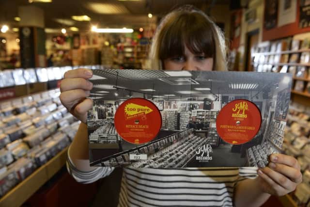 Sarah Jane Mathers-Reilly at Jumbo Records with the celebratory 45rpm 7inch single featuring the Leeds bands Menace Beach and Post War Glamour Girls.